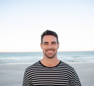 Man standing on beach smiling